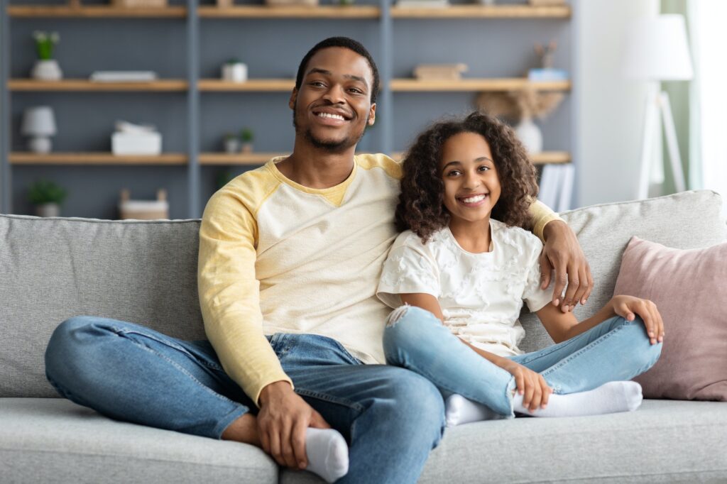 Happy african american family kid and dad spending time together