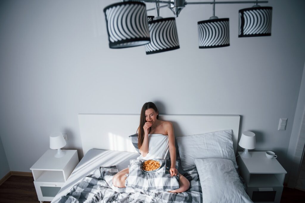 Alone in the room. Pretty young woman lying on the bed at morning time